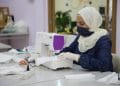 A Syrian woman sews a mask to be worn for protection against COVID-19 in Hatay, Turkey, June 14, 2020