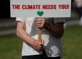 A protester from the Climate Coalition demonstrates, with 100 hundred days to go before the start of the COP26 climate summit, in Parliament Square, London, Britain, July 23, 2021